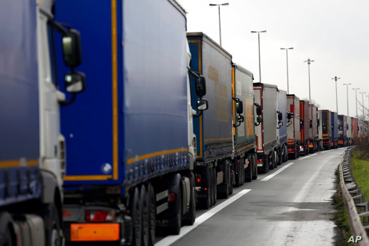 Lorries queue along the A16 motorway to board ferries to reach England, near Calais, northern France, Wednesday, Dec. 9 2020…