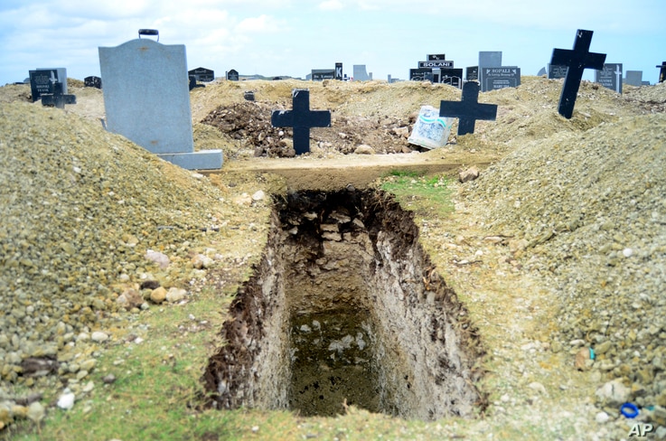 A freshly-dug grave sits at the Motherwell Cemetery in Port Elizabeth, South Africa, Friday, Dec. 4, 2020. Health Minister…