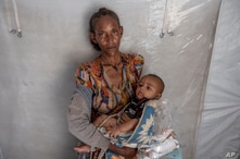 Tigrinyan refugee 38-year-old Rega Tsfay, malnourished mother of her 3-moth-old son Itbarak