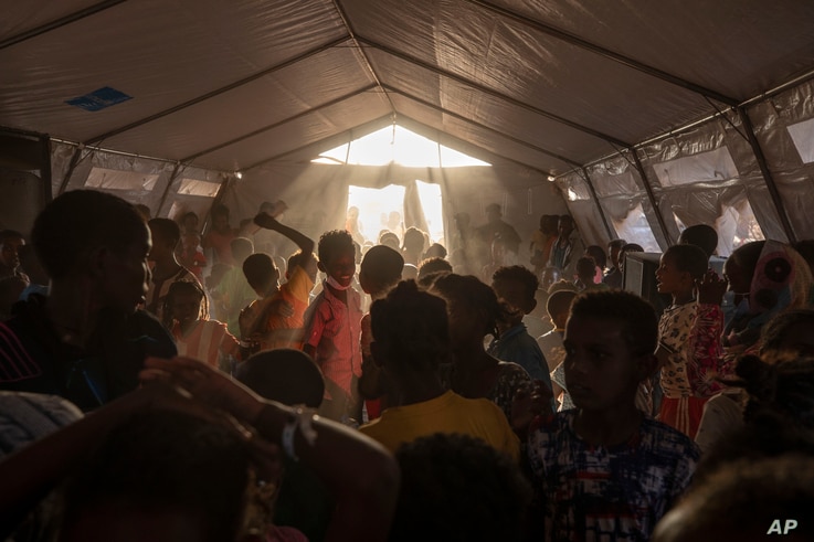 Tigray refugee children sing and dance inside a tent run by UNICEF for children's activities, in Umm Rakouba refugee camp.
