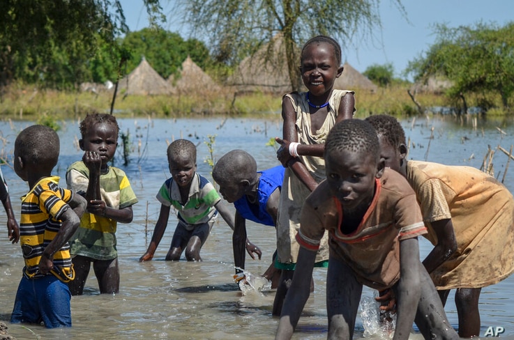 Children wash themselves in muddy floodwaters in the village of Wang Chot, Old Fangak county, Jonglei state, South Sudan…