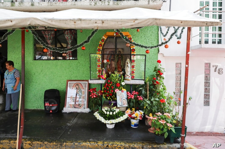 A makeshift altar honors the Virgin of Guadalupe outside a home in a neighborhood of Mexico City, Saturday, Dec. 12, 2020. For…
