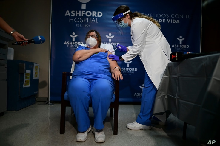 Epidemiologist Hilda Aleman reacts upon receiving the Pfizer-BioNTech COVID-19 vaccine, in San Juan, Puerto Rico, Dec. 15, 2020. 