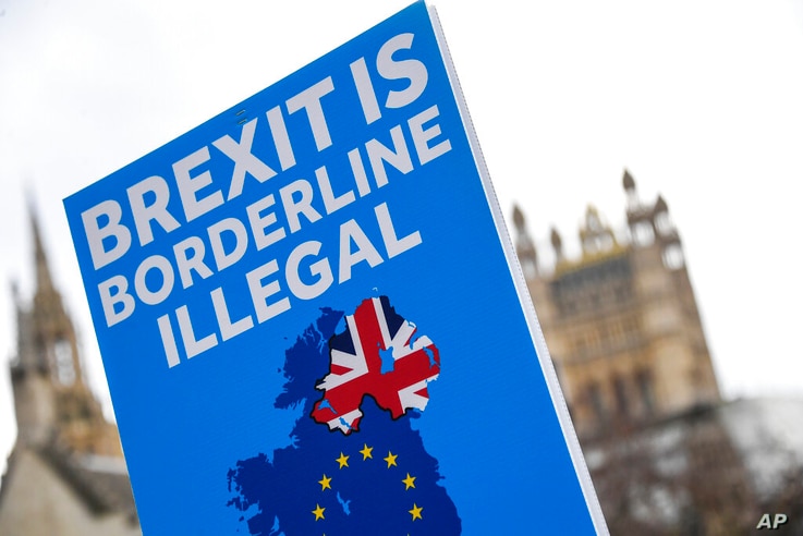 An anti-Brexit placard is held in Parliament Square, in London, Wednesday, Dec. 16, 2020. Ursula von der Leyen said Wednesday…