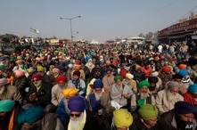 Protesting farmers listen to a speaker at the Delhi- Haryana border, outskirts of New Delhi, India, Dec. 17, 2020.