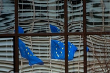 European Union flags are reflected in a window of the European Council in Brussels, Saturday, Dec. 19, 2020. The European Union…