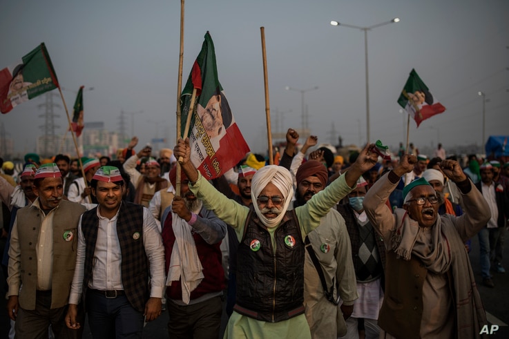 Indian farmers shout slogans as they block a major highway during a protest against new farm laws at the Delhi-Uttar Pradesh state border, India, on Dec. 5, 2020.