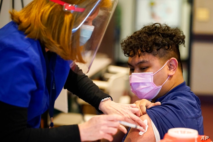 EMT Christian Ventura receives the Moderna COVID-19 vaccine at the Chester County Government Services Center, in West Chester, Pa., Dec. 29, 2020. 