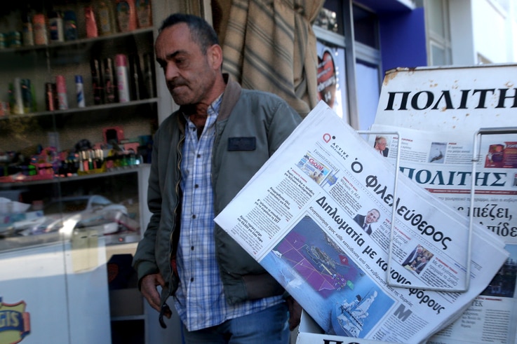 A man reads walks past  Cypriot newspaper with a  front page carrying  a photo montage about Turkey's actions over Cyprus and…