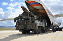 Military vehicles and equipment, parts of the S-400 air defense systems, are unloaded from a Russian transport aircraft, at Murted military airport in Ankara, Turkey, July 12, 2019. 