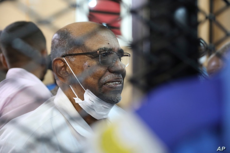 FILE - In this Sept. 15, 2020 file photo, Sudan's ousted president Omar al-Bashir sits at the defendant's cage during his trial…