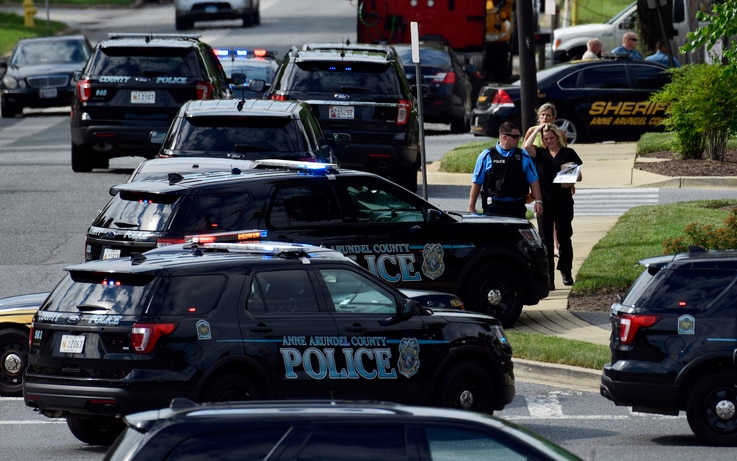 Police secure the scene of a shooting at the building housing the Capital Gazette newspaper in Annapolis, Md., June 28, 2018. 