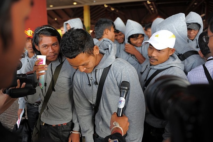 Cambodian trafficked fishermen return from Indonesia after being freed or escaping from slave-like conditions on Thai fishing vessels, talks to journalists at the Phnom Penh International airport, December 12, 2011. (AFP)