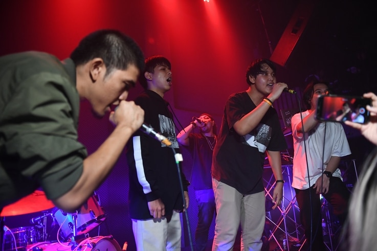 An audience member, second from right, raps with members of Rap Against Dictatorship on stage in Bangkok,  Oct. 27, 2018. The group has touched a nerve with an impassioned and now-viral music video lobbing fiery rhymes at the ruling junta.