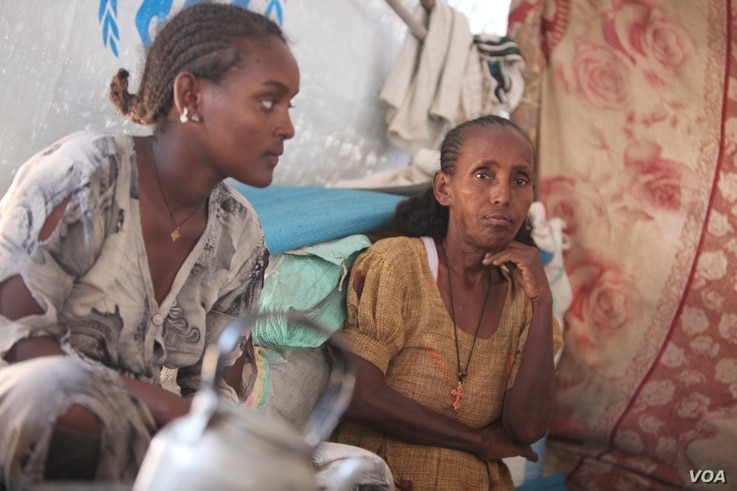 Ageza Neba (R) and her daughter, Ksana Giday (L) fled the conflict in Ethiopia, leaving behind loved ones, including Neba’s son, pictured on Dec. 10, 2020 in the Um Rakouba camp in Sudan. (VOA/ Mohaned Bilal) 
