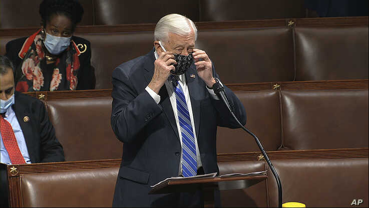 In this image from video, Rep. Steny Hoyer, D-Md., takes his face covering off as he speaks on the floor of the House of…