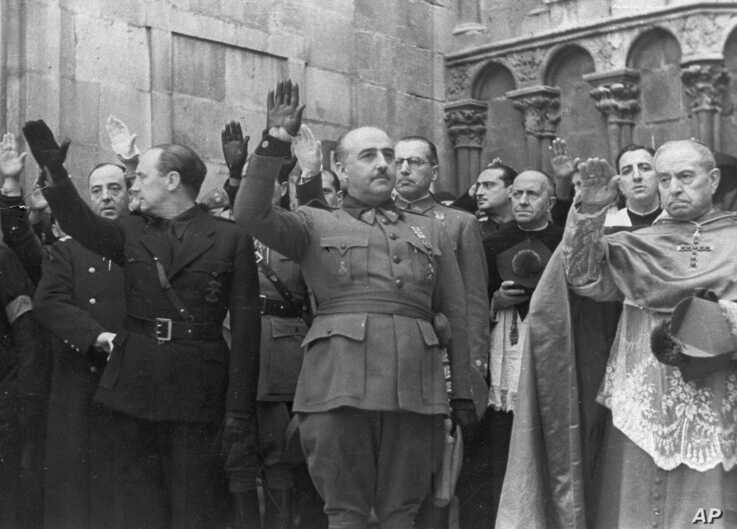 FILE - Former Spanish dictator Francisco Franco, center, is seen at a ceremony in Burgos, Spain, Nov. 20, 1938.