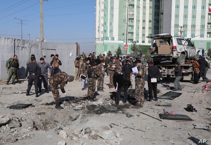 Afghan security personnel investigate at the site of a bomb attack in Kabul, Afghanistan, Dec. 15, 2020. A bombing and a shooting attack on Tuesday in the Afghan capital of Kabul killed several people, including Kabul's deputy governor. 