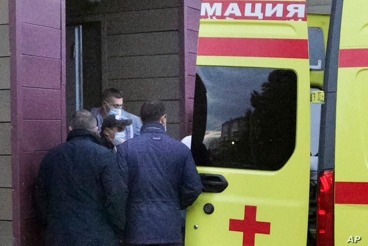Russian dissident Alexei Navalny, not seen in photo, on a stretcher is transferred into an ambulance before being driven to an airport, at the Omsk Ambulance Hospital, in Omsk, Russia, Aug. 22, 2020.