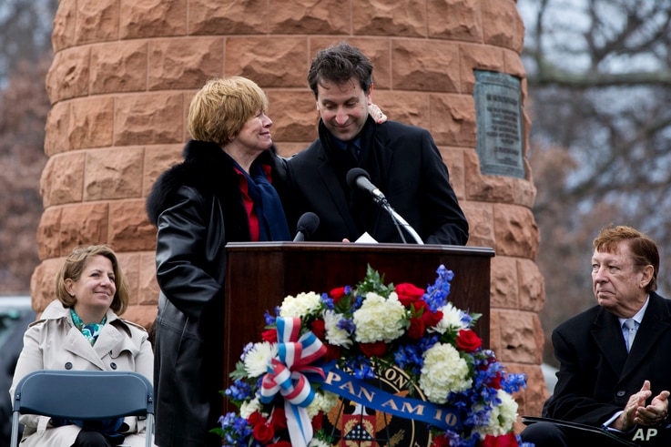 FILE - Kathy Daniels Tedeschi, L, whose husband died in the Pan Am Flight 103 bombing, hugs Ken Dornstein, producer of 
