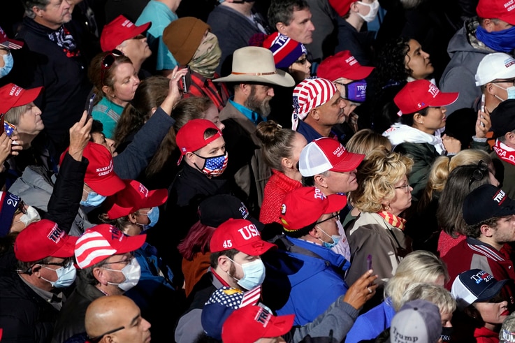 Supporters listens as President Donald Trump speaks at a campaign rally for Senate Republican candidates, Sen. Kelly Loeffler,…