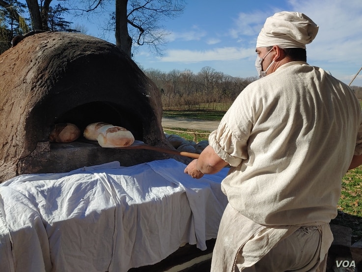 Justin Cherry bakes bread in a clay, wood-fired oven he made. He uses the same kind of wheat that was grown on Mount Vernon 