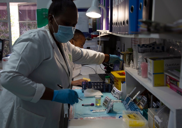 Laboratory technicians test a blood sample for HIV infection at the Reproductive Health and HIV Institute (RHI) in Johannesburg…