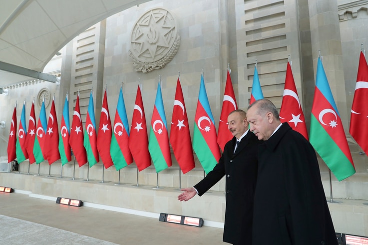 Turkey's President Recep Tayyip Erdogan, right, is welcomed by Azerbaijan's President Ilham Aliyev, center, in Baku, Azerbaijan…