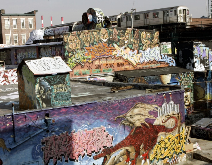(FILES) In this file photo taken on February 22, 2006, the 7 Train passes by the 5 Pointz Building in Long Island City, Queens,…
