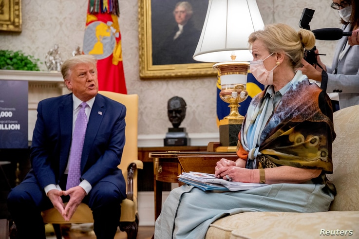 FILE - President Donald Trump speaks during a meeting as White House coronavirus response coordinator Dr. Deborah Birx looks on, in the Oval Office of the White House in Washington, Aug. 5, 2020.
