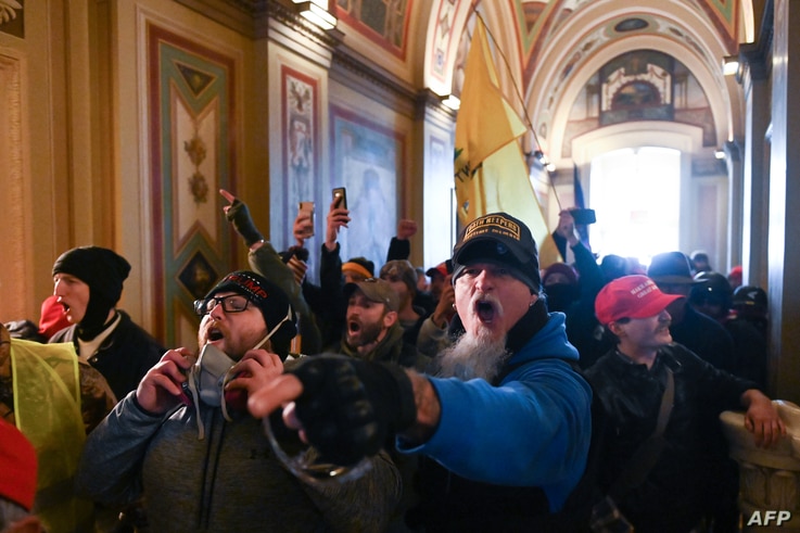 Supporters of US President Donald Trump protest inside the US Capitol on January 6, 2021, in Washington, DC. - Demonstrators…