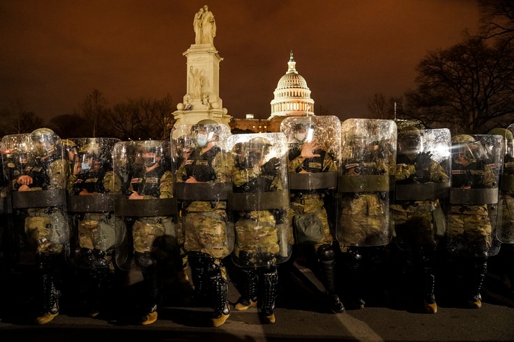 District of Columbia National Guard stand outside the Capitol, Wednesday night, Jan. 6, 2021, after a day of rioting protesters…