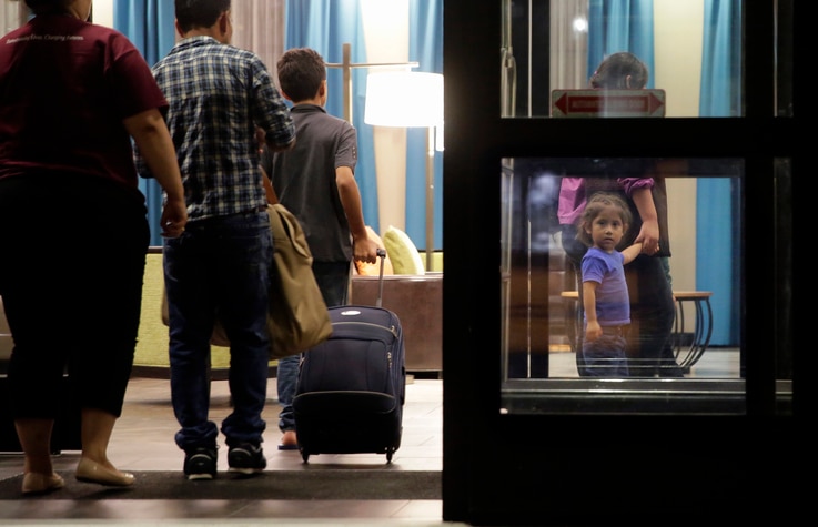 Immigrants seeking asylum who were recently reunited arrive at a hotel, in San Antonio, July 23, 2018. A federal judge says he will give the Trump administration six months to identify children who were separated from their families at the U.S.-Mexic...