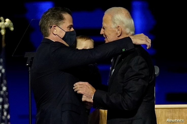 Democratic 2020 U.S. presidential nominee Joe Biden embraces his son Hunter Biden at an election rally.