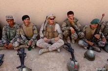 FILE PHOTO: A U.S. Marine(C) talks with Afghan National Army (ANA) soldiers during a training in Helmand province, Afghanistan,…