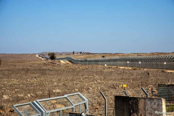 A general view picture shows a security fence near the border area between Israel and Syria, in the Israeli-occupied Golan…