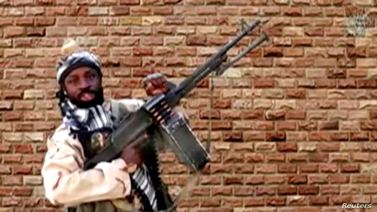 FILE PHOTO: Boko Haram leader Abubakar Shekau holds a weapon in an unknown location in Nigeria in this still image taken from…