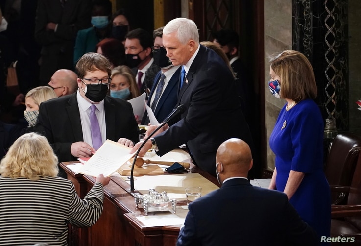 U.S. Vice President Mike Pence and Speaker of the House Nancy Pelosi (D-CA) take part in a joint session of Congress to certify…