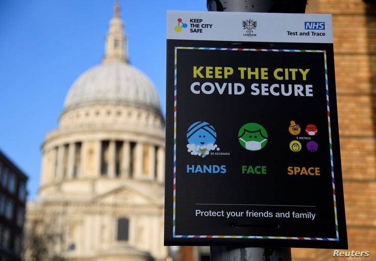 A public health information sign is seen with St. Paul's Cathedral seen behind amidst a lockdown during the spread of the…