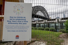 A signs adorns a security fence near the harbour foreshore ahead of New Years Eve in Sydney, Australia, Thursday, Dec. 31, 2020…