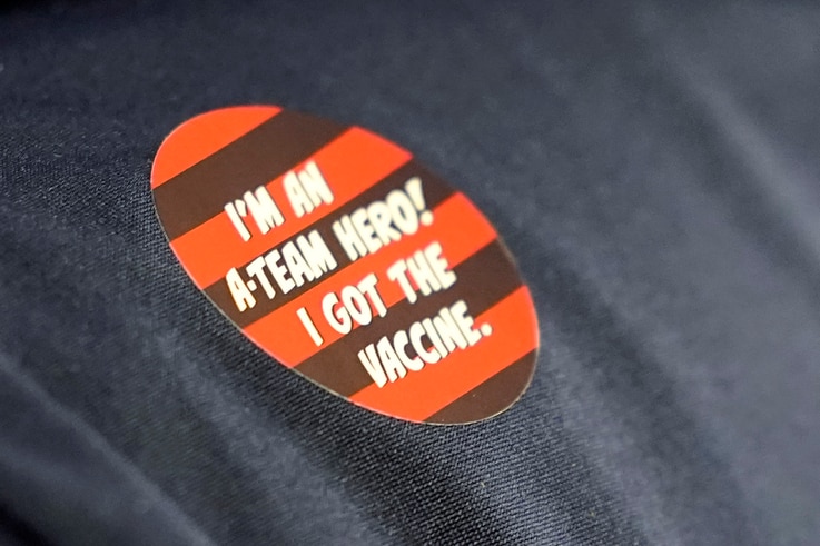 A worker at Queen Anne Healthcare, a skilled nursing and rehabilitation facility in Seattle, wears a sticker that reads 