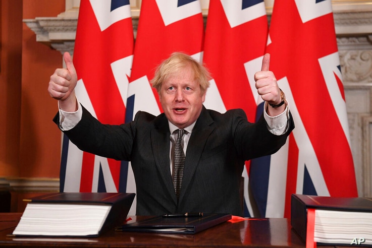 Britain's Prime Minister Boris Johnson gives a thumbs up gesture after signing the EU-UK Trade and Cooperation Agreement at 10…
