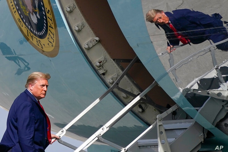 President Donald Trump boards Air Force One at Palm Beach International Airport, Thursday, Dec. 31, 2020, in West Palm Beach,…