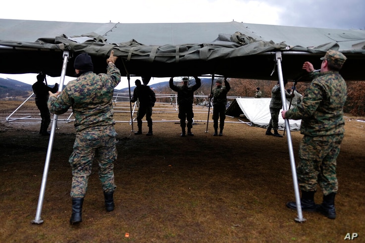 Bosnian soldiers put up the tents at the Lipa camp outside Bihac, Bosnia, Friday, Jan. 1, 2021. The Bosnian army on Friday were…