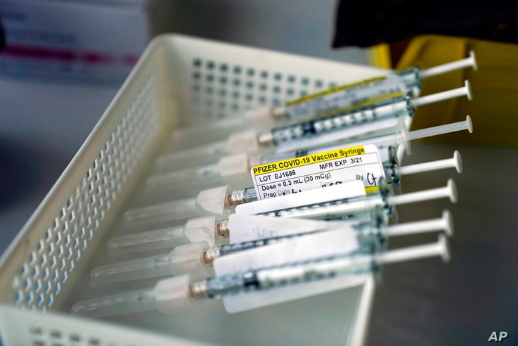 FILE - In this Jan. 7, 2021, file photo syringes containing the Pfizer-BioNTech COVID-19 vaccine sit in a tray in a vaccination…