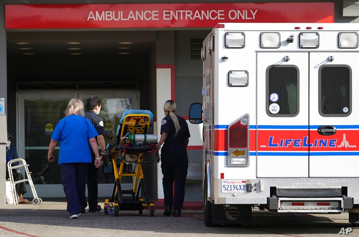 FILE - In this Jan. 5, 2021 file photo a LifeLine Ambulance arrives at the CHA Hollywood Presbyterian Medical Center (CHA HPMC)…