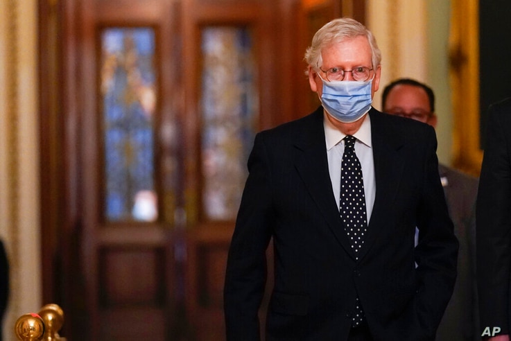 In this Jan. 6, 2021, photo, Senate Majority Leader Mitch McConnell of Ky., walks from the Senate floor to his office on…