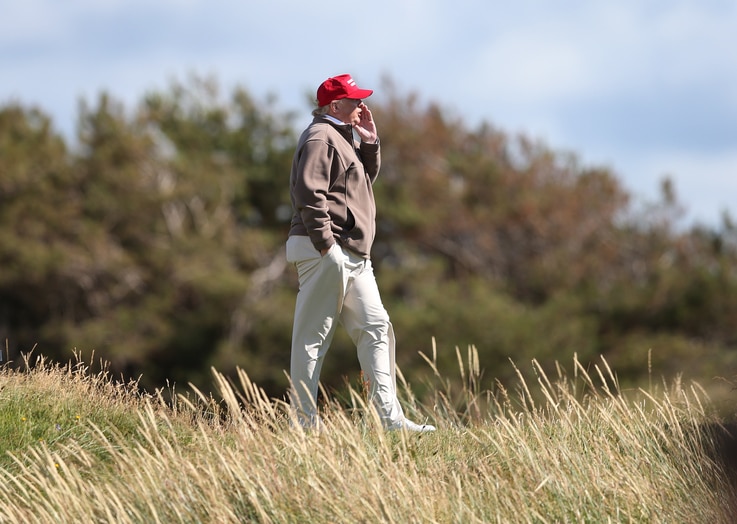FILE - U.S. Presidential contender Donald Trump walks near the 16th green of the Turnberry golf course in Turnberry, Scotland, July 30, 2015. A British online petition seeks to ban Trump from entering the UK following his comments on Muslims.