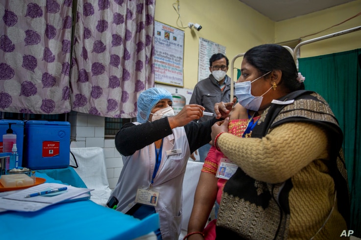 A health worker engages in a COVID-19 vaccine delivery system trial in New Delhi, India, Jan. 2, 2021.