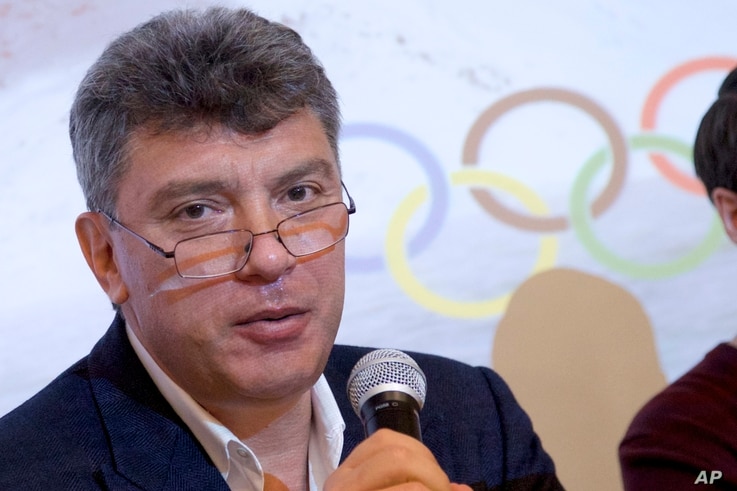 FILE  - Boris Nemtsov, a former Russian deputy prime minister and opposition leader, presents a report claiming widespread corruption during preparations for the 2014 Winter Games in Sochi, at a news conference in Moscow, May 30, 2013.